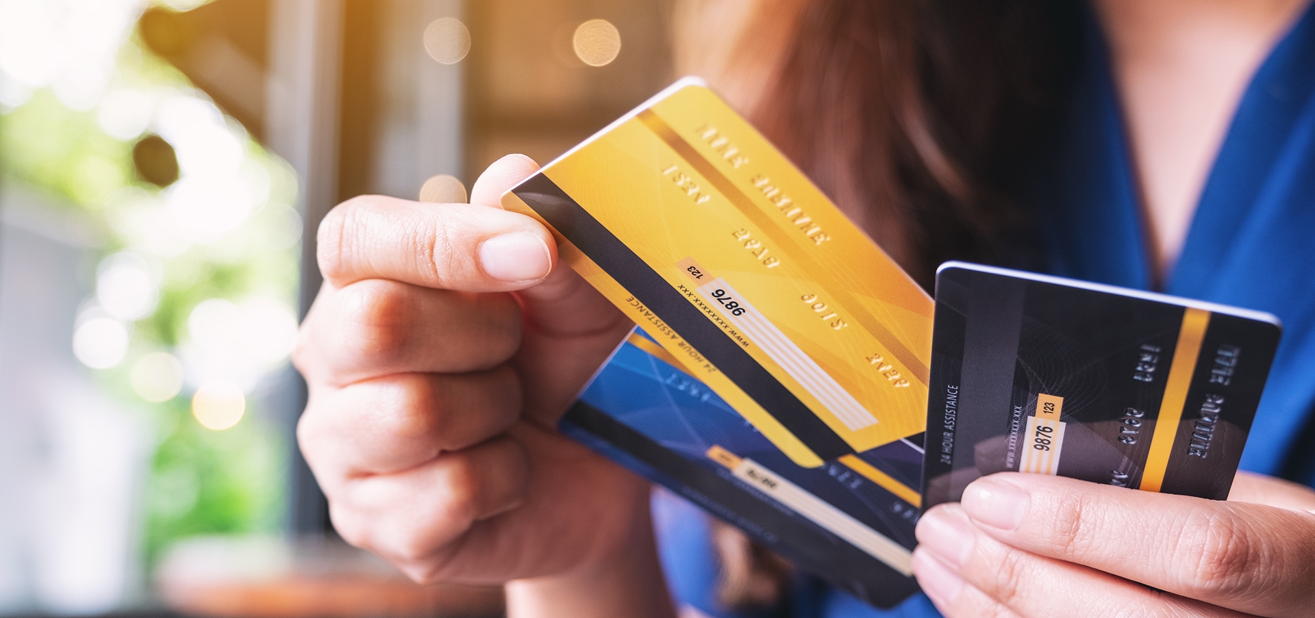 person holding debit and credit cards